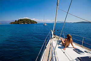 Woman Sitting on Sailboat | Sebastus Sailing