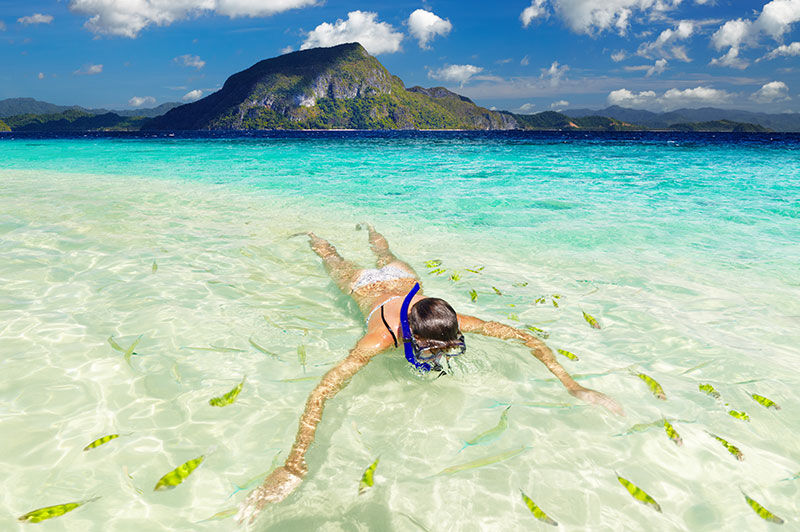 Woman snorkeling in the Caribbean clear waters