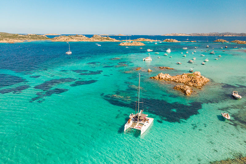 catamaran in crystal clear waters of La Maddalena archipelago
