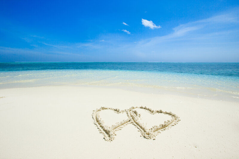 Hearts drawn into the sand on a beach coast | Sebastus Sailing