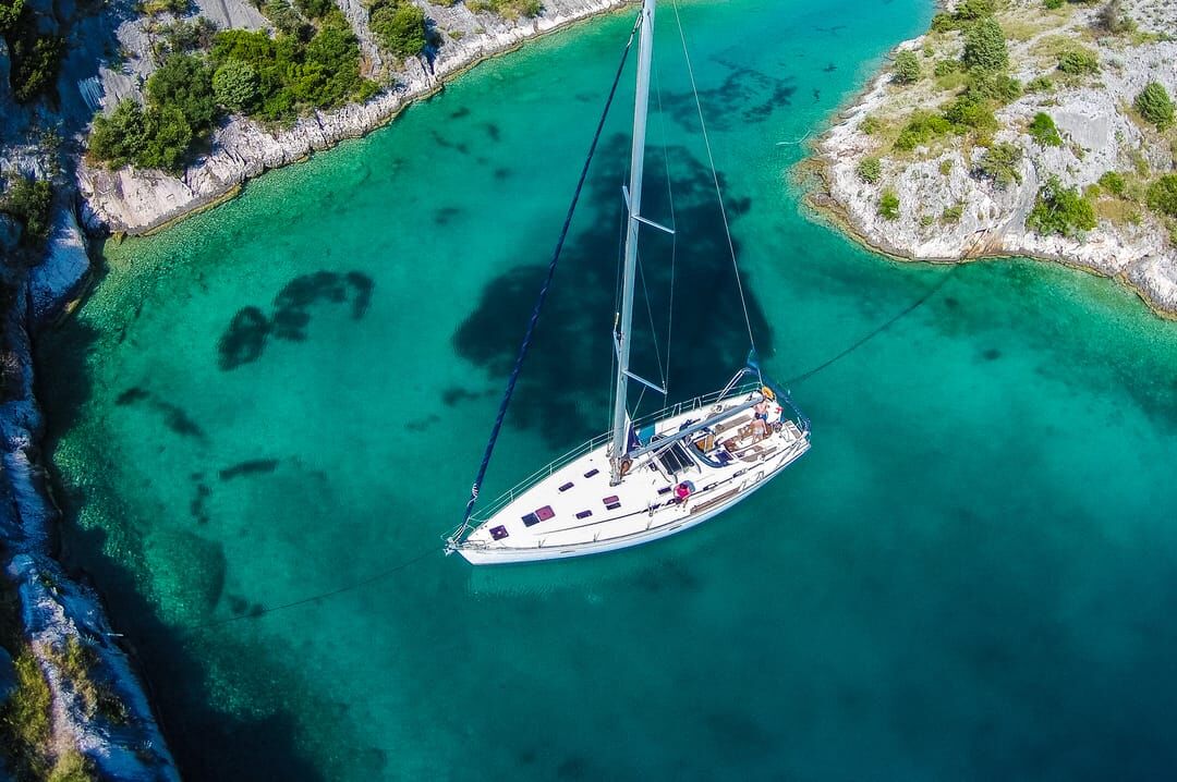 boat anchored in a quiet bay, aerial view