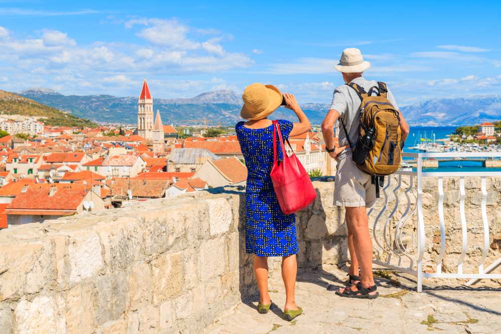 Tourist couple takes picture at scenic outlook in Croatia