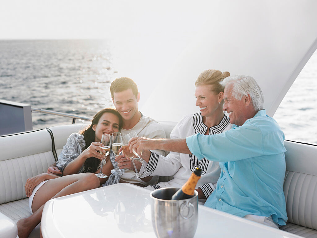 Family luxury yacht charter - family sailing and enjoying drinks on a boat