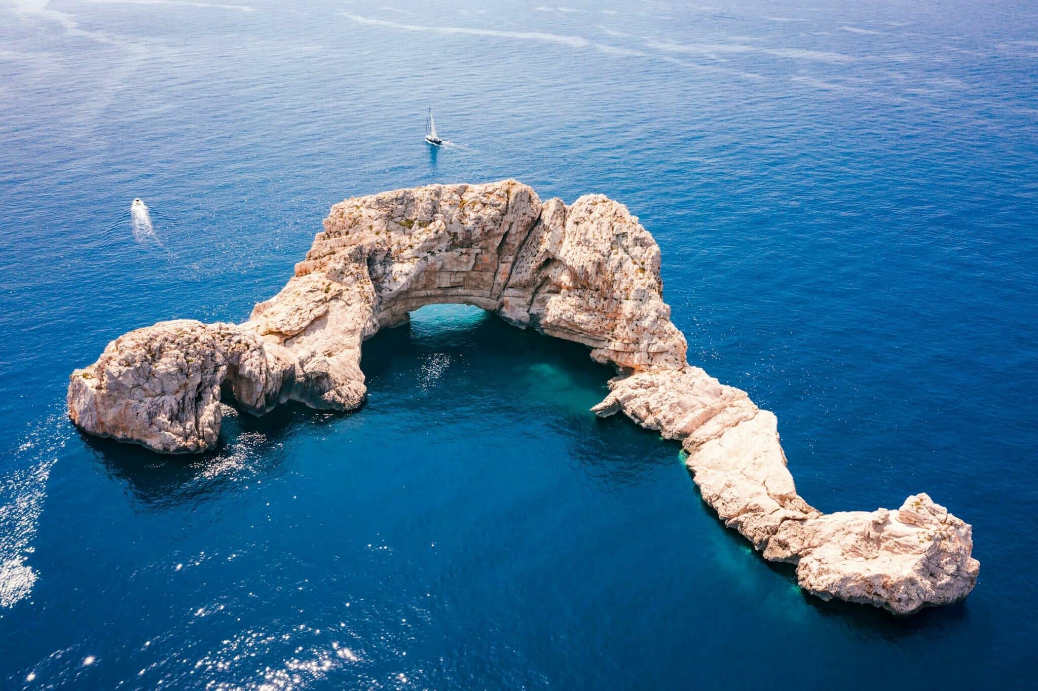 aerial view to a rock on the sea